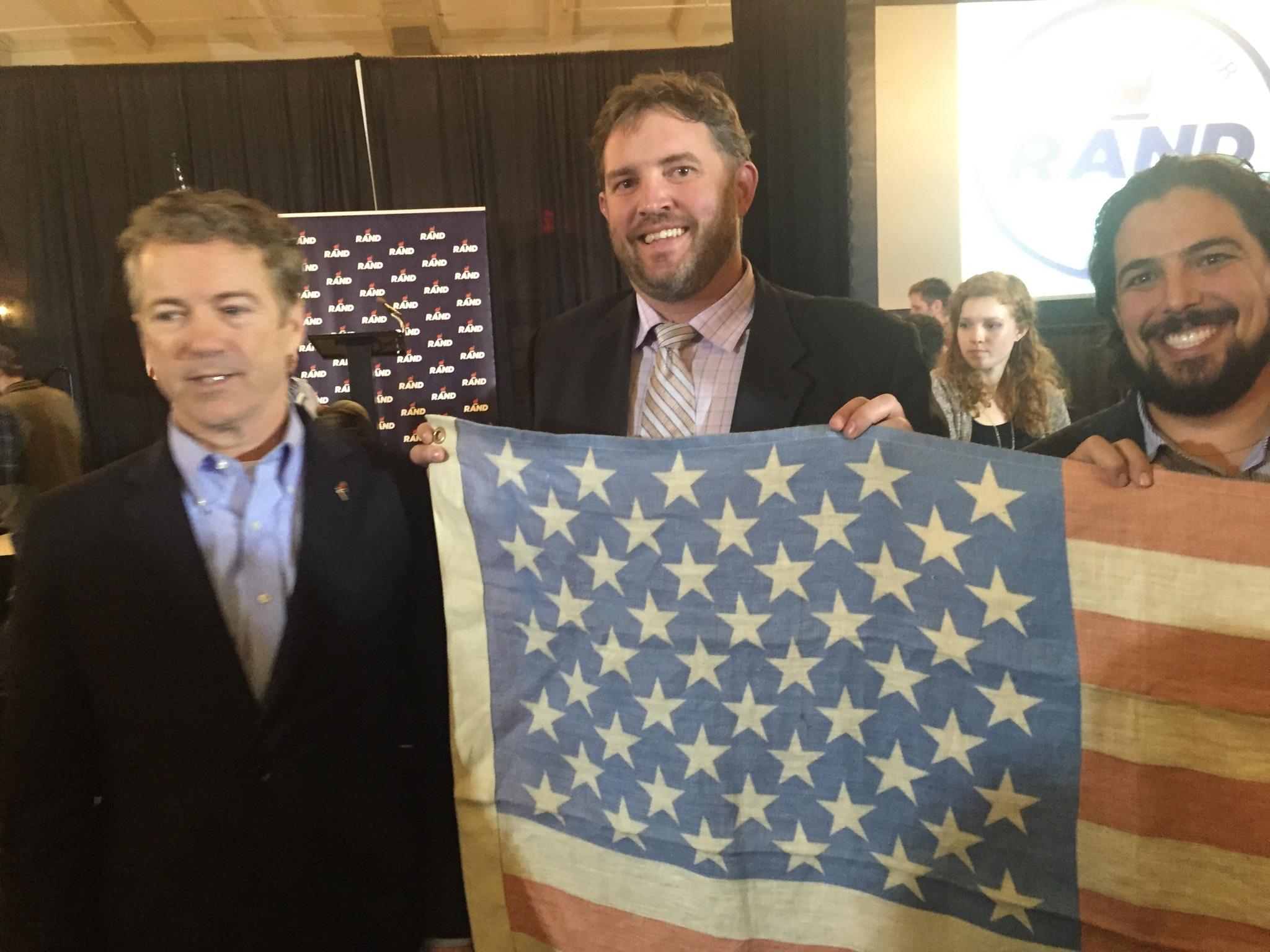 Rick Trojan of the Hemp Road Trip takes a photo with hemp supporter and (at the time) 2016 Republican presidential candidate as they both hold up a Kentucky-made hemp flag. Hemp cultivation is legal in the state of Kentucky. Image Courtesy of The Hemp Road Trip